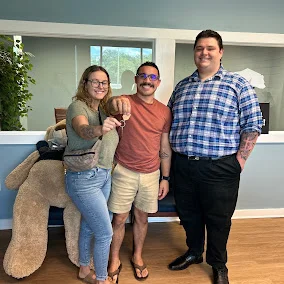 Stone Merton with two clients holding up the keys to their new home