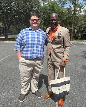 Stone Merton smiling with a client outside after their meeting